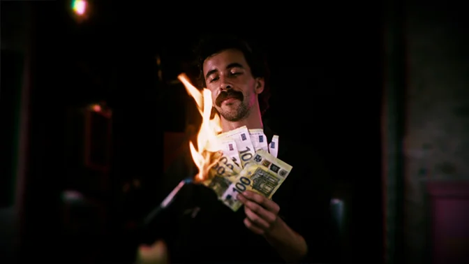 bike mechanic burning 100 euro bills, with a smile